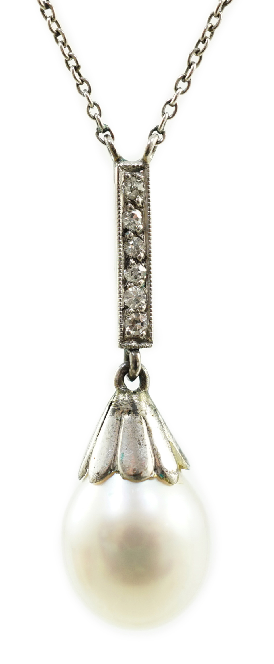 A 1920's platinum, single stone pear shaped cultured pearl and six stone diamond chip set pendant necklace